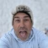 Man in beanie, surprised expression.